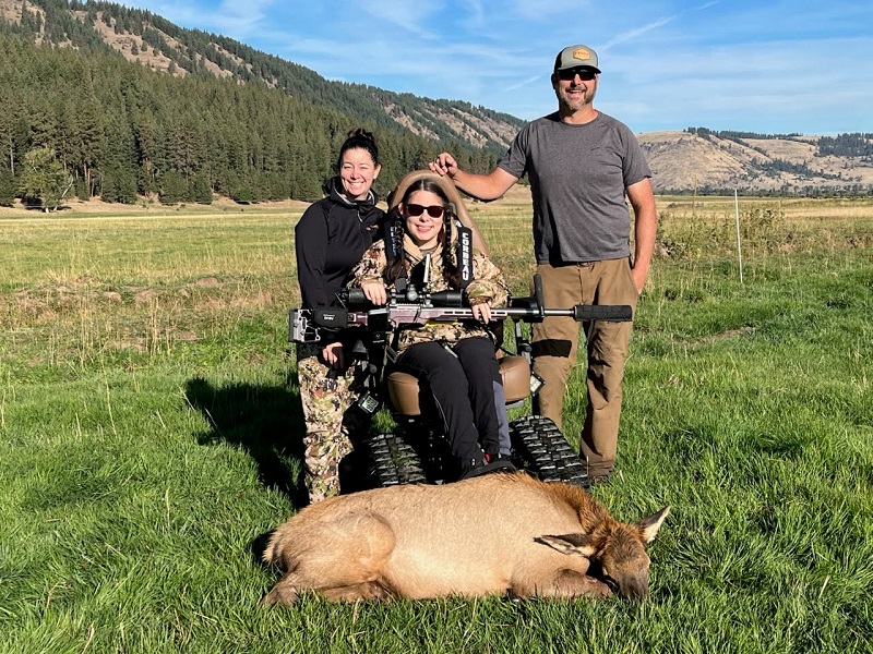 Adaptive hunter with family and harvested elk